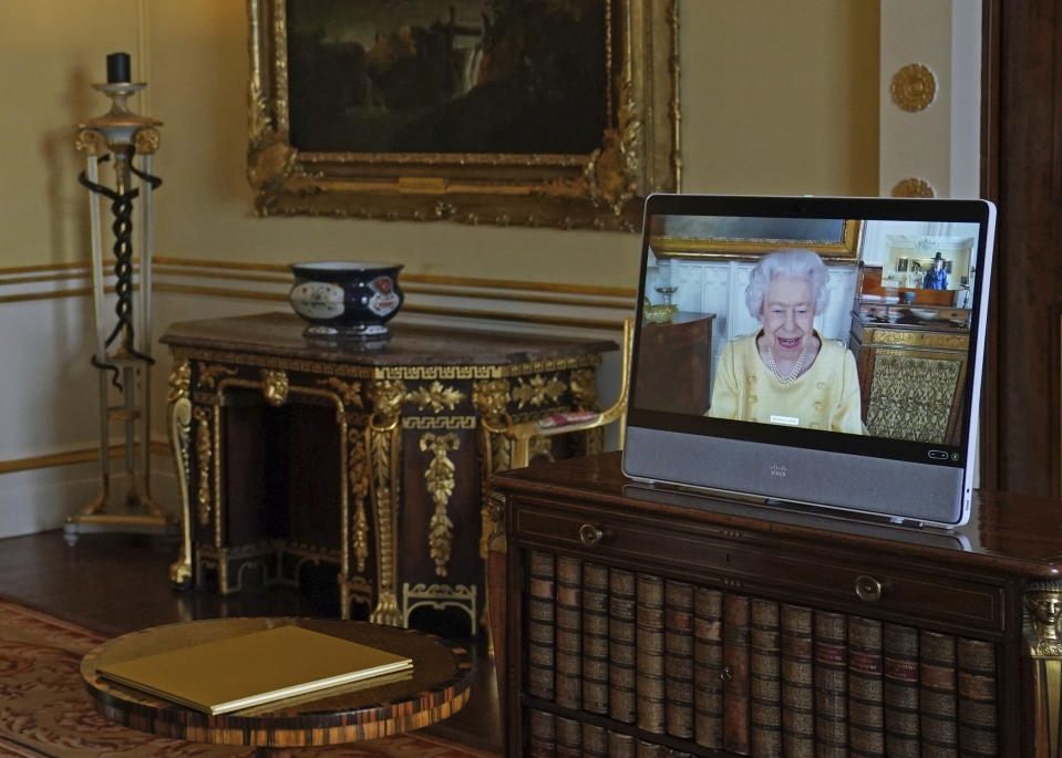 Queen Elizabeth II appears on a screen via videolink from Windsor Castle, where she is in residence, during a virtual audience at Buckingham Palace, London, Tuesday, Oct. 26, 2021. (Victoria Jones/Pool via AP)