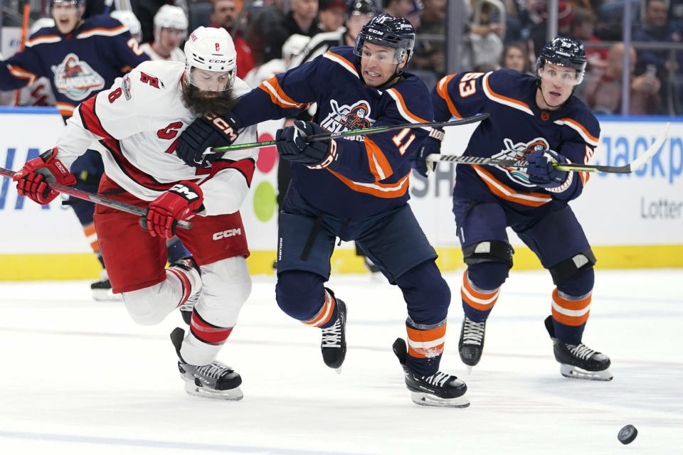 New York Islanders left wing Zach Parise (11) skates against Carolina Hurricanes defenseman Brent Burns (8) during the second period of an NHL hockey game Saturday, Dec. 10, 2022, in Elmont, N.Y. (AP Photo/Mary Altaffer)