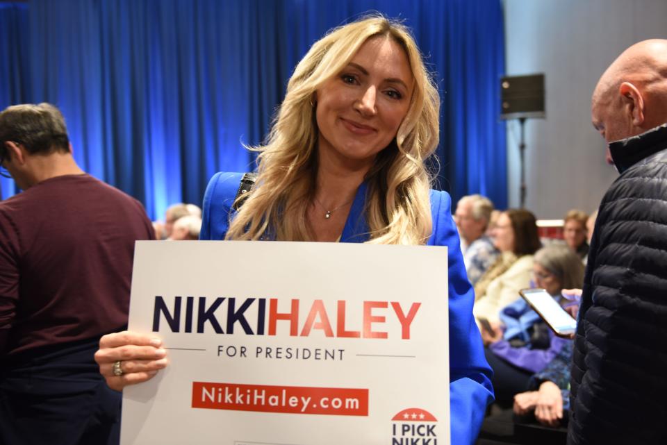 Natilya Koppes poses with a Nikki Haley sign in Bloomington, Minn. on Feb. 26, 2024 at her campaign rally ahead of the Super Tuesday presidential nominating contest.