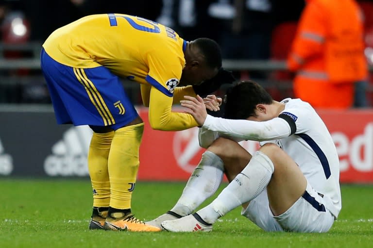 Down and out: Tottenham's Son Heung-Min is consoled at the final whistle by Juventus midfielder Kwadwo Asamoah