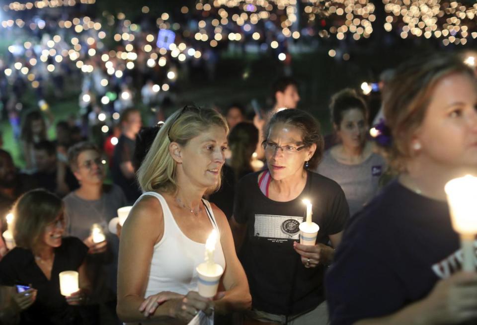 People gather at a candlelit vigil in Charlottesville (AP)