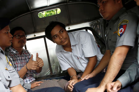 FILE PHOTO: Detained Reuters journalists Kyaw Soe Oo and Wa Lone are escorted in a police vehicle after a court hearing in Yangon, Myanmar, August 20, 2018. REUTERS/Ann Wang