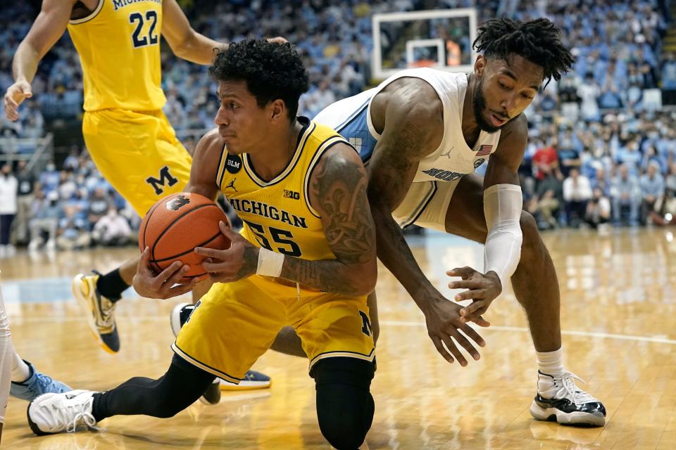 North Carolina’s Leaky Black tangles with Michigan guard Eli Brooks, front, last month during the Tar Heels’ blowout win.