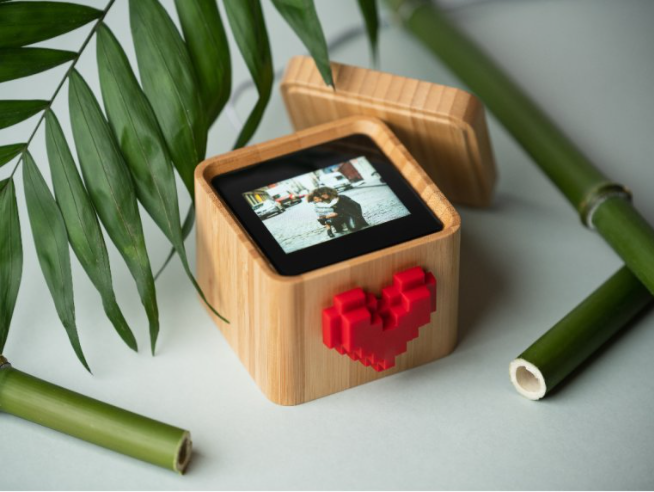 Open bamboo box, displaying a photo of mom and boy hugging on the screen inside. 