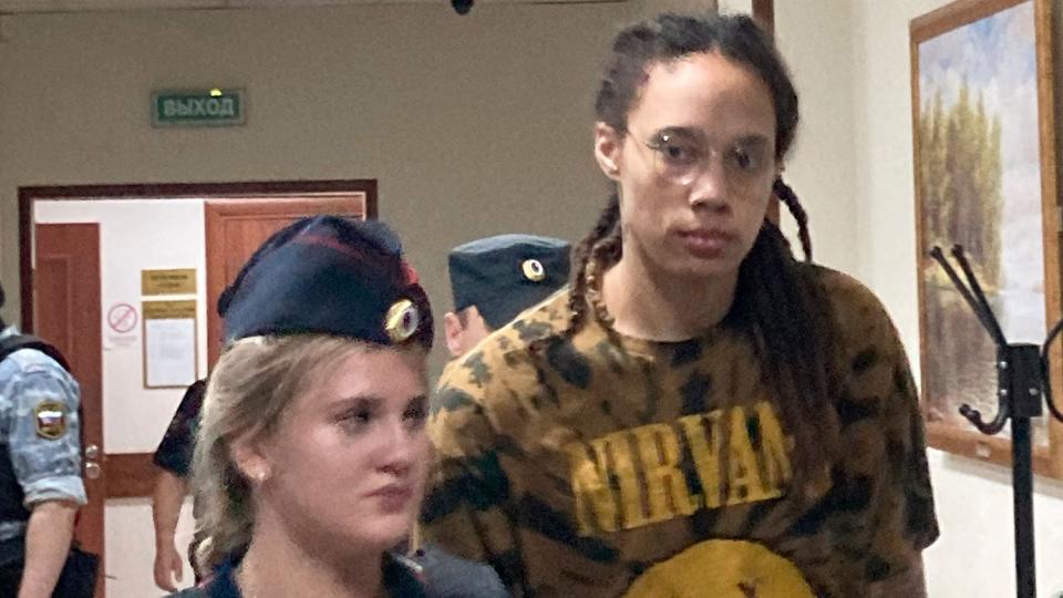 Brittney Griner is escorted to a courtroom for a hearing in the Khimki district court