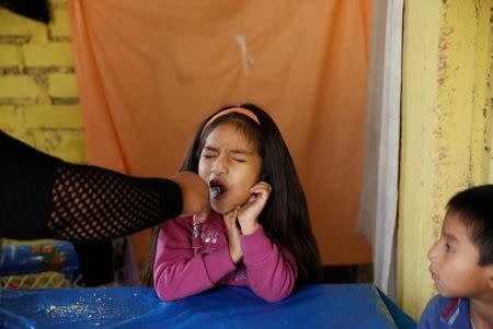 Jazmin, 6, sister of Jose Luis, receives Isoniazid Preventive Therapy in Carabayllo in Lima, Peru July 14, 2016. REUTERS/Mariana Bazo