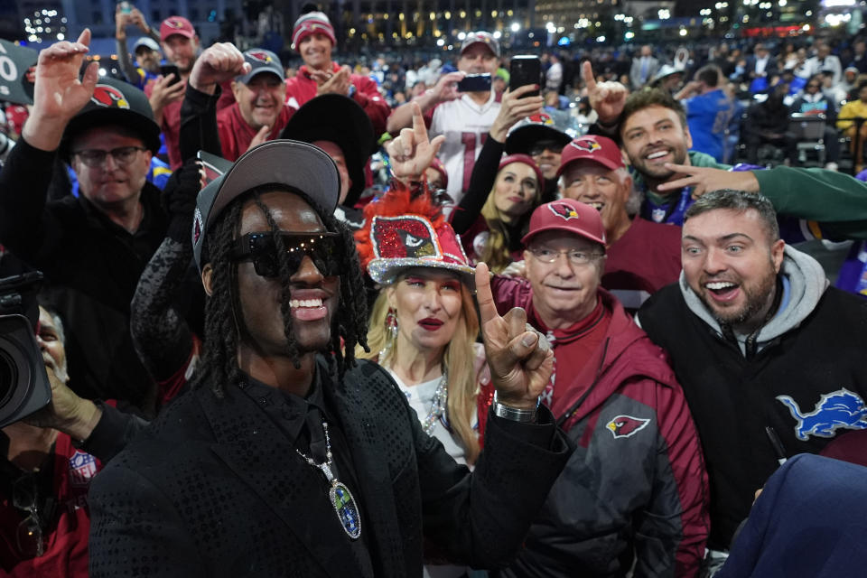 Ohio State wide receiver Marvin Harrison Jr. celebrates with fans after being chosen by the Arizona Cardinals with the fourth overall pick during the first round of the NFL football draft, Thursday, April 25, 2024, in Detroit. (AP Photo/Paul Sancya)