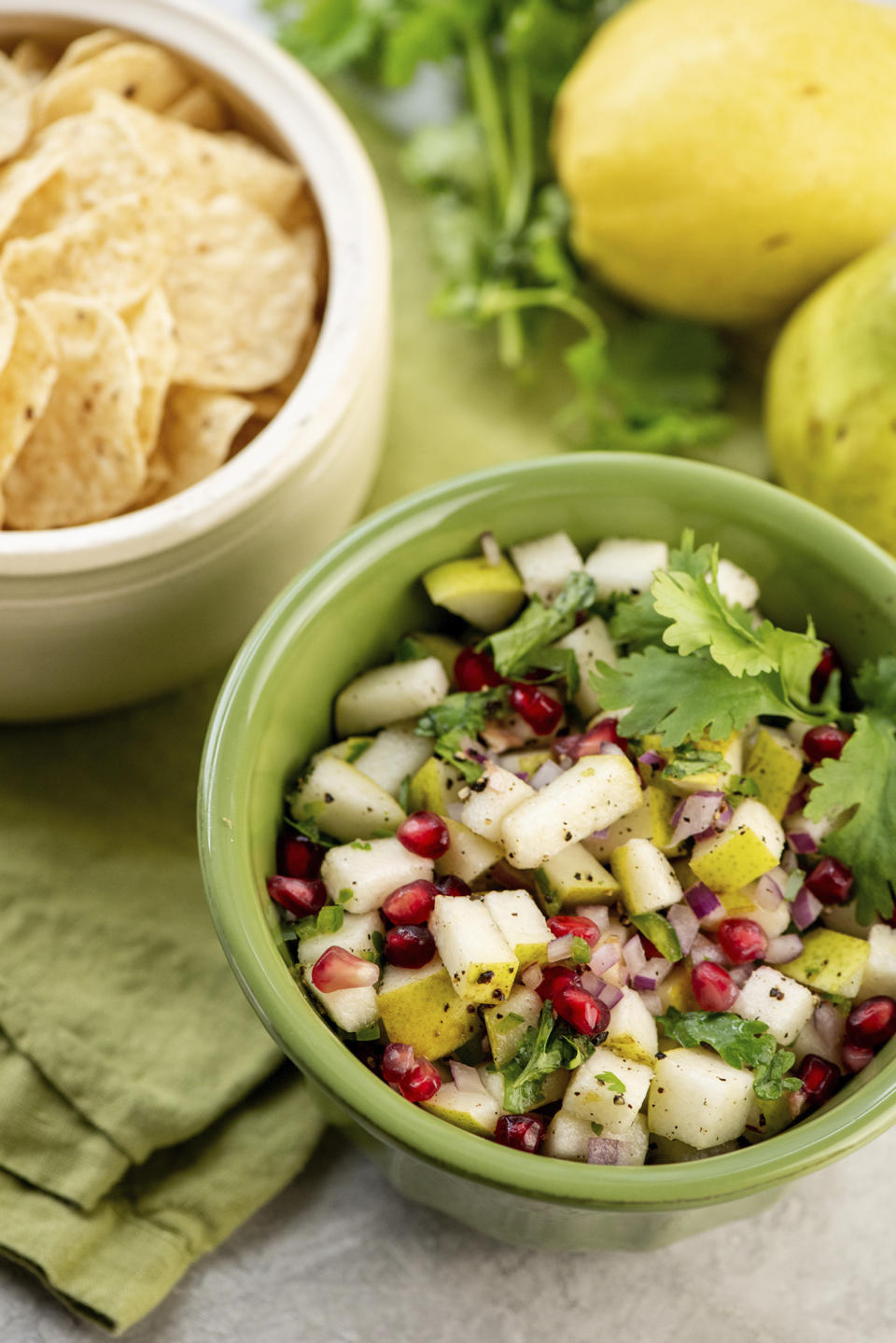 This image shows a recipe for spice pear and cilantro salsa. While everyone loves a classic tomato-based salsa, you can shake things up with different fruit-based salsas. (Cheyenne Cohen via AP)