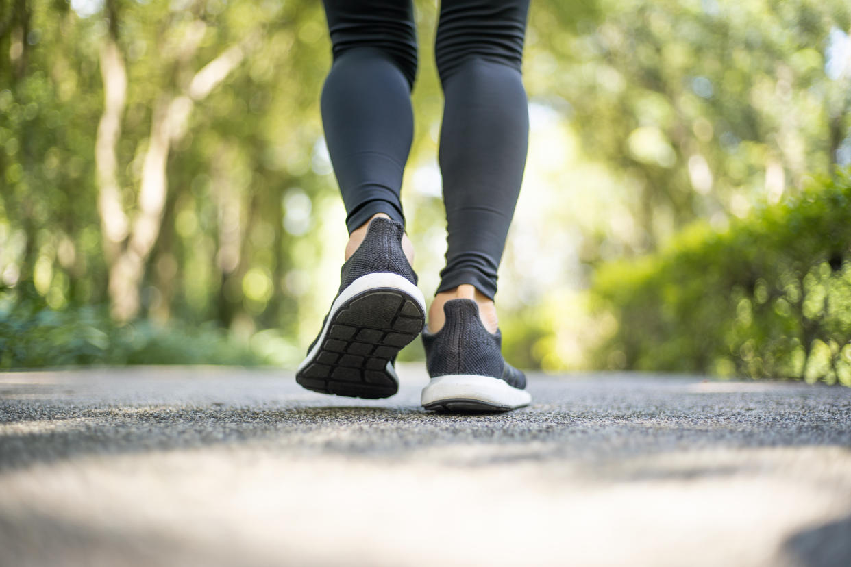 Close up of running shoes and women feet when warming up activity before running.