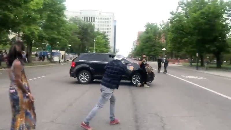 A vehicle runs over a protester as it speeds through a protest in Denver held following the death of George Floyd in Minneapolis