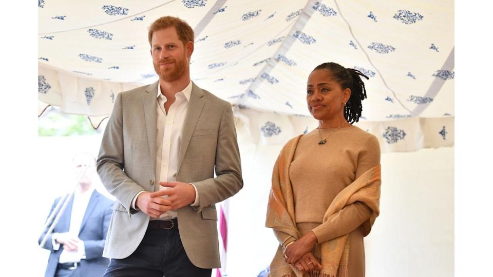 Prince Harry in a grey blazer and Doria Ragland in a cream outfit