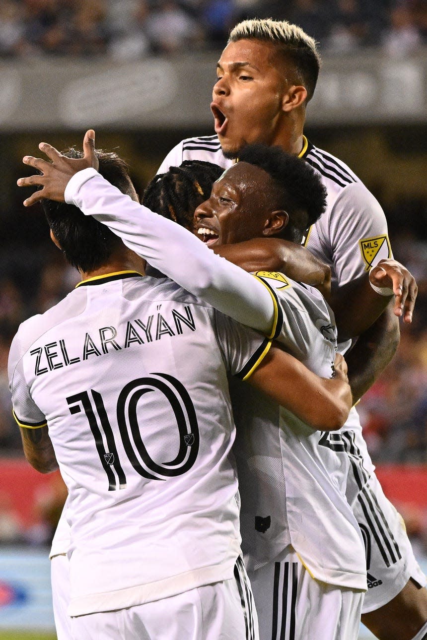 Jul 9, 2022; Chicago, Illinois, USA;  Columbus Crew SC midfielder Derrick Etienne (22), middle, celebrates his second goal of the second half against the Chicago Fire FC with midfielder Lucas ZelarayÃ¡n (10) and forward Cucho (9)  at Soldier Field. Mandatory Credit: Jamie Sabau-USA TODAY Sports