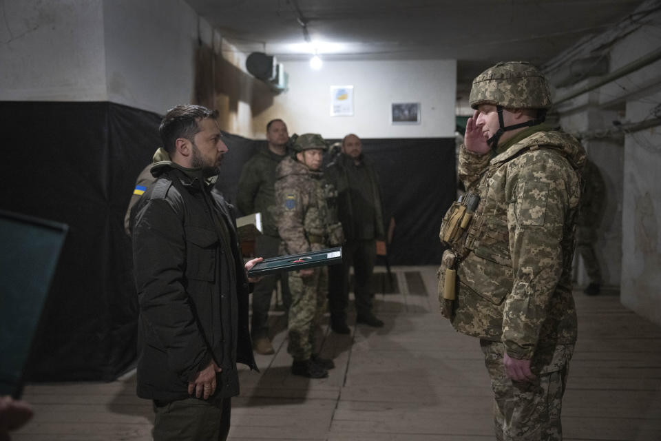 Ukrainian President Volodymyr Zelenskyy honors servicemen during his visit to the front-line city of Kupiansk, Kharkiv region, Ukraine, Thursday, Nov. 30, 2023. (AP Photo/Efrem Lukatsky)