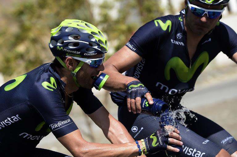 Spain's Alejandro Valverde (L) gets water from a teammate during the fourth stage of the 2015 Tour of Oman, on February 20, 2015