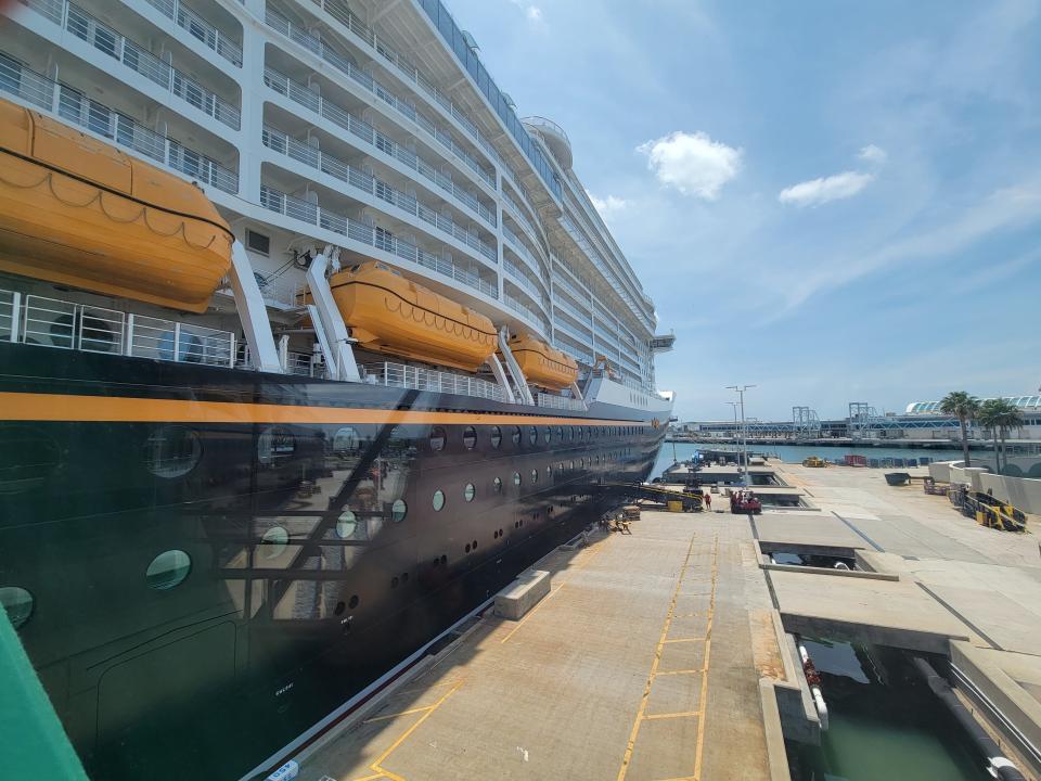 exterior shot of disney wish cruise ship docked at a port