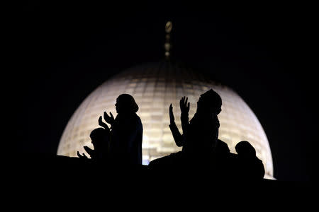 Muslim women pray in front of the Dome of the Rock, on the compound known to Muslims as Noble Sanctuary and to Jews as Temple Mount, during Laylat al-Qadr in Jerusalem's Old City June 11, 2018. REUTERS/Ammar Awad/Files