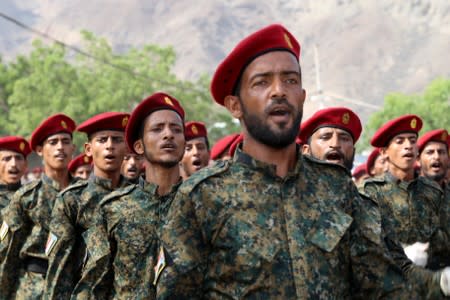 Newly recruited troopers march during a graduation parade in Aden, Yemen