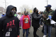 People march during protest rally for Marcellis Stinnette who killed by Waukegan Police last Tuesday in Waukegan, Ill., Thursday, Oct. 22, 2020. Stinnette was killed and his girlfriend and the mother of his child, Tafara Williams, was wounded when a police officer in Waukegan opened fire Tuesday night after police said Williams' vehicle started rolling toward the officer following a traffic stop. (AP Photo/Nam Y. Huh)