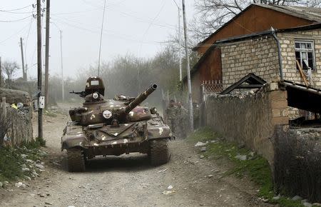 A tank of the self-defense army of Nagorno-Karabakh moves on the road in the village of Talish April 6, 2016. REUTERS/Staff