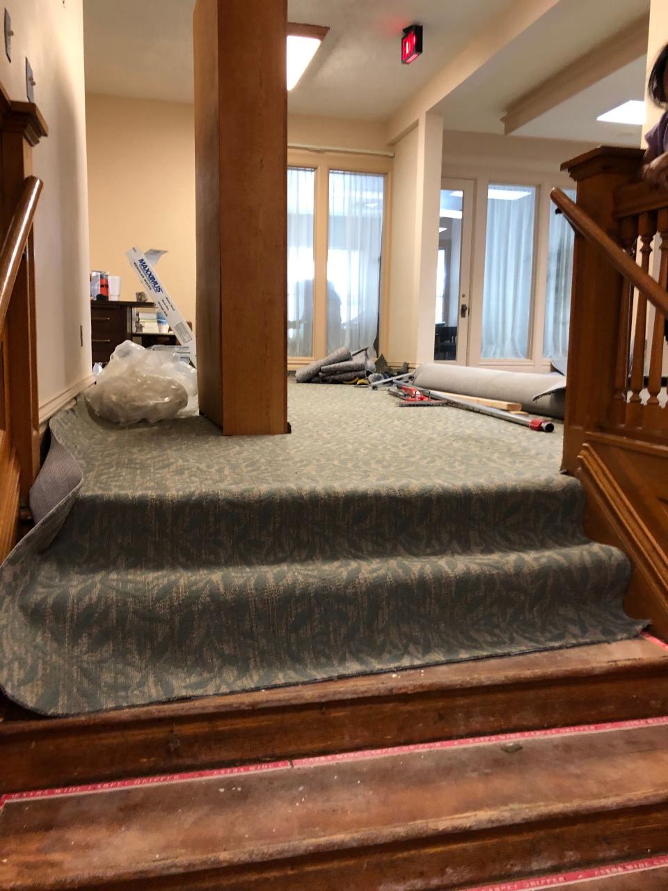 Looking at the top of the stairs in the Bivins Home where correct period style carpet is being installed. This floor contained five bedrooms with a lavatory in each room. The stairs entered into a living room. At the end of the room there is a door, directly over the front door, which opens onto a beautiful balcony.
