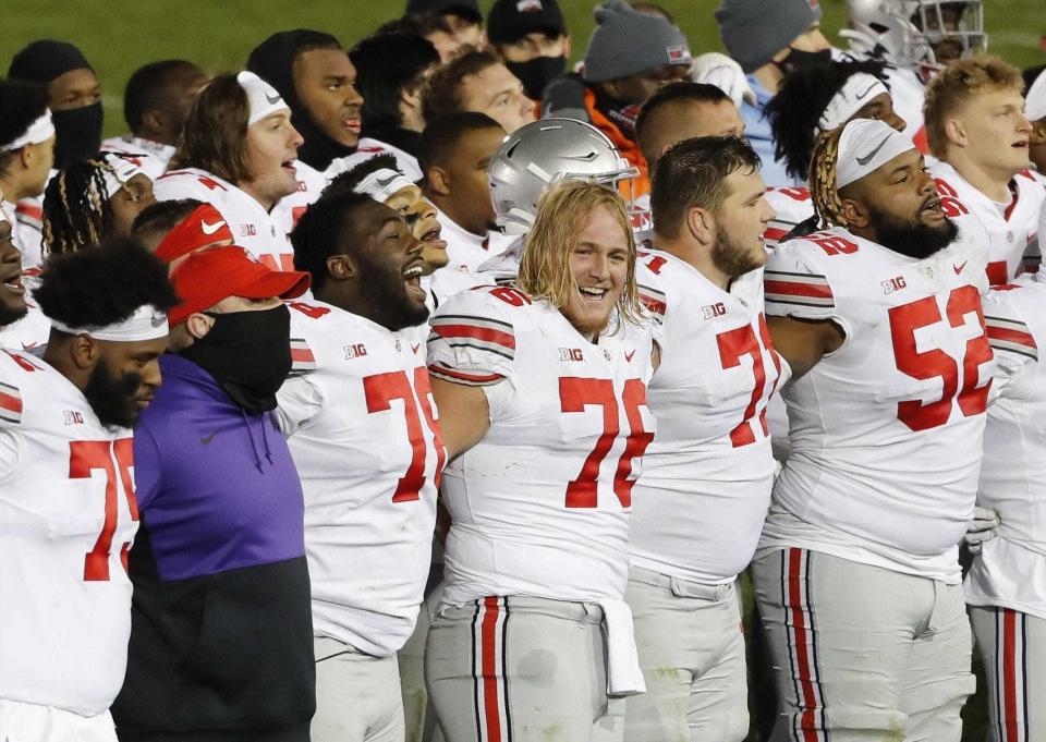 State guard Harry Miller (76) joins his teammates in singing "Carmen Ohio" after a win at Penn State.