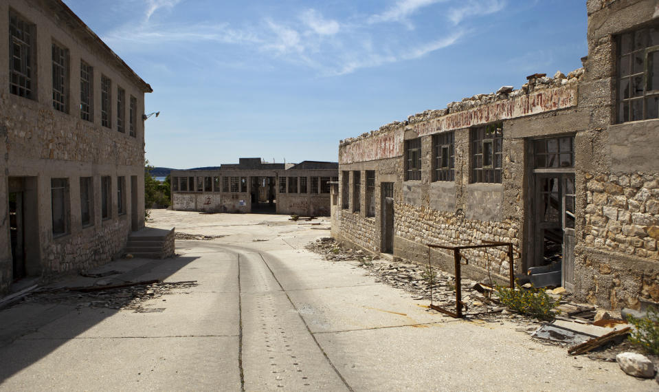 In this photo taken June 28, 2012, ruined prison buildings are seen at the Adriatic island of Goli Otok. The prison island housed up to 16,000 political prisoners over an eight-year period. They ended up there after being accused by Tito's regime of expressing sympathy toward Josef Stalin and his hardline Soviet dictatorship. (AP Photo/Darko Bandic)