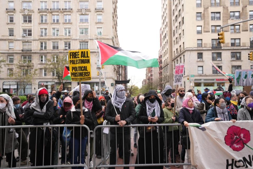 A Palestinian flag being waved above the demonstrators near Columbia University. James Keivom