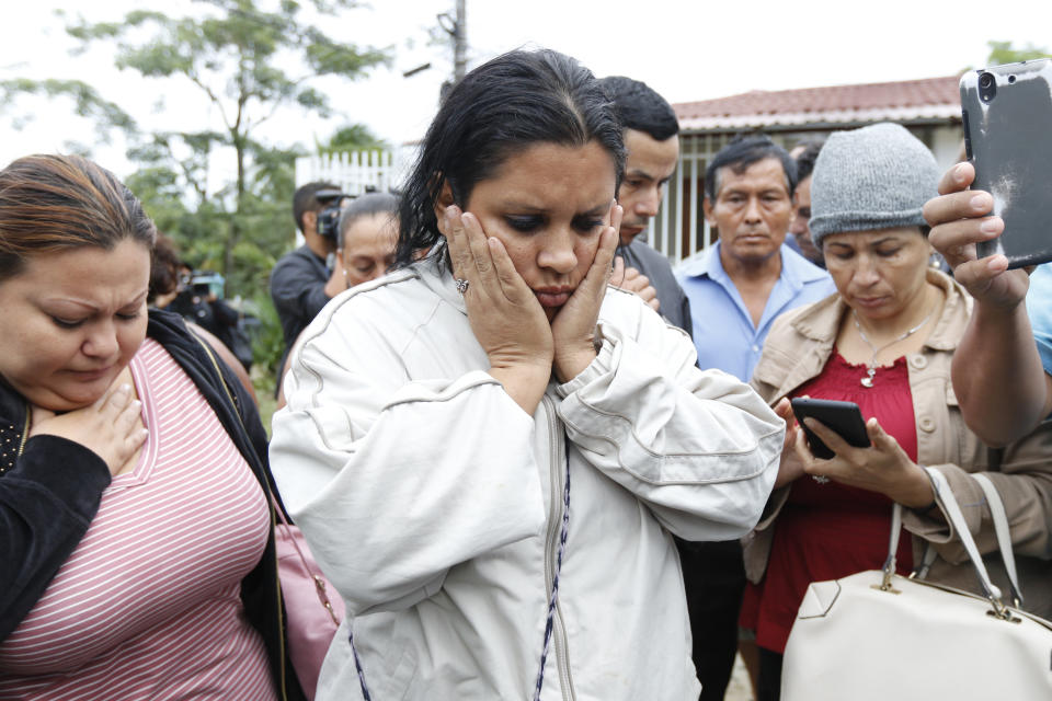 Family members wait for news from their imprisoned relatives, outside the Tela prison where at least 18 inmates were killed on Friday, in Tela, Honduras, Saturday, Dec. 21, 2019. Authorities say inmates, some with firearms, rioted. The riot came several days after Honduras declared a state of emergency in its prison system. (AP Photo/Delmer Martinez)