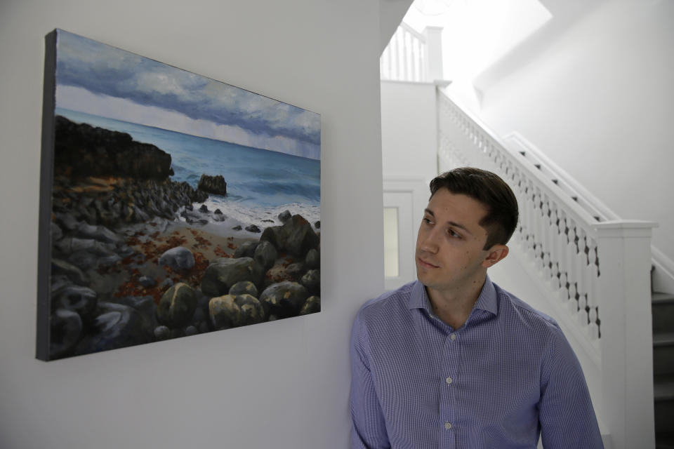 Dane Shikman stands by a photo showing where the ashes of his mother, Elizabeth Gaunt, were scattered in Ireland, while at his home in San Francisco on April 19, 2019. Shikman's mother, a former social worker with mental health and substance abuse problems, killed herself in 2015 at the Lake County, Calif, jail, after pleading to see a doctor and repeatedly begging for help. Her son's wrongful death t resulted in a $2 million county settlement. (AP Photo/Eric Risberg)