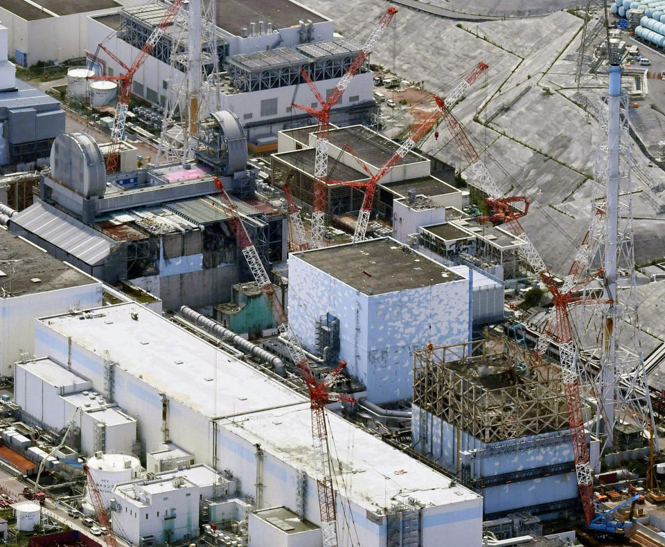 FILE - This Sept. 4, 2017, aerial file photo shows Fukushima Dai-ichi nuclear power plant reactors, bottom from right, Unit 1, Unit 2 and Unit 3, in Okuma town, Fukushima prefecture, northeastern Japan. The utility company operating Fukushima's tsunami-wrecked nuclear power plant said Friday, Aug. 9, 2019 it will run out of space for tanks to store massive amounts of treated but still contaminated water in three years, adding pressure for the government and the public to reach consensus on what to do with the water. (Daisuke Suzuki/Kyodo News via AP, File)