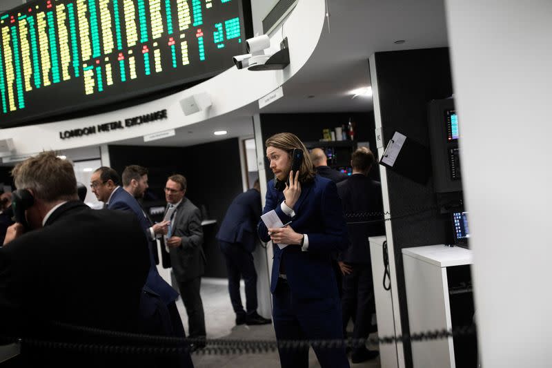 Traders work on the floor of the London Metal Exchange, in London