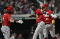 Cincinnati Reds' Elly De La Cruz (44) celebrates with Jonathan India (6) and Joey Votto (19) after scoring against the Cleveland Guardians during the fifth inning of a baseball game Tuesday, Sept. 26, 2023, in Cleveland. (AP Photo/Sue Ogrocki)