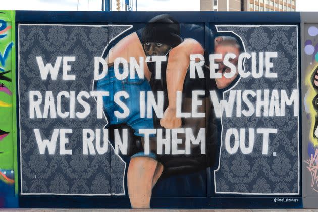 Lionel Stanhope's artwork in Lewisham, based on a photo taken by Reuters photographer Dylan Martinez of a Black Lives Matter protester Patrick Hutchinson carrying Bryn Male outside the Southbank Centre. It was painted over with the words: