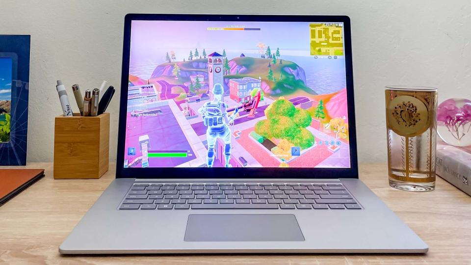Surface Laptop 5 on desk with Fortnite playing on-screen