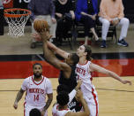 Los Angeles Clippers' Serge Ibaka (9) drives to the basket as Houston Rockets' Kelly Olynyk (41) defends during the first quarter of an NBA basketball game Friday, May 14, 2021, in Houston. (Bob Levey/Pool Photo via AP)