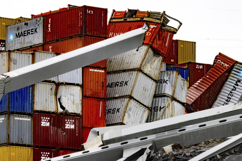 Shipping containers are crushed as wreckage of the Francis Scott Key Bridge rests on the container ship Dali, Wednesday, April 3, 2024, in Baltimore. (AP Photo/Julia Nikhinson)