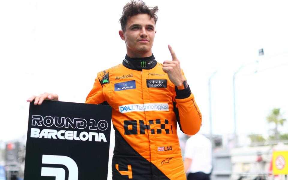 Lando Norris celebrates taking pole position