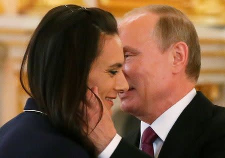 Russian President Vladimir Putin greets track-and-field athlete Yelena Isinbayeva during a personal send-off for members of the Russian Olympic team at the Kremlin in Moscow, Russia, July 27, 2016. REUTERS/Maxim Shemetov