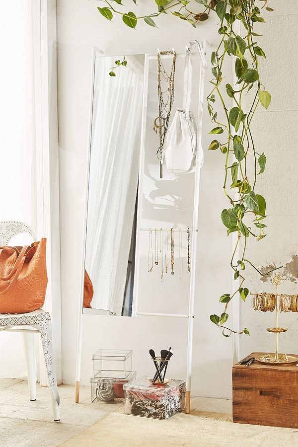 <a href="https://www.urbanoutfitters.com/shop/leni-leaning-mirror?category=furniture&amp;color=010" target="_blank">This frame</a> features a full-length mirror, hooks for hanging and an additional bar for other accessories.