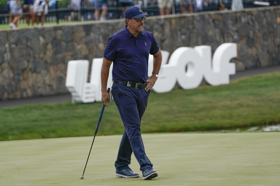 Phil Mickelson watches on the 18th hole during the first round of the Bedminster Invitational LIV Golf tournament in Bedminster, NJ., Friday, July 29, 2022. (AP Photo/Seth Wenig)