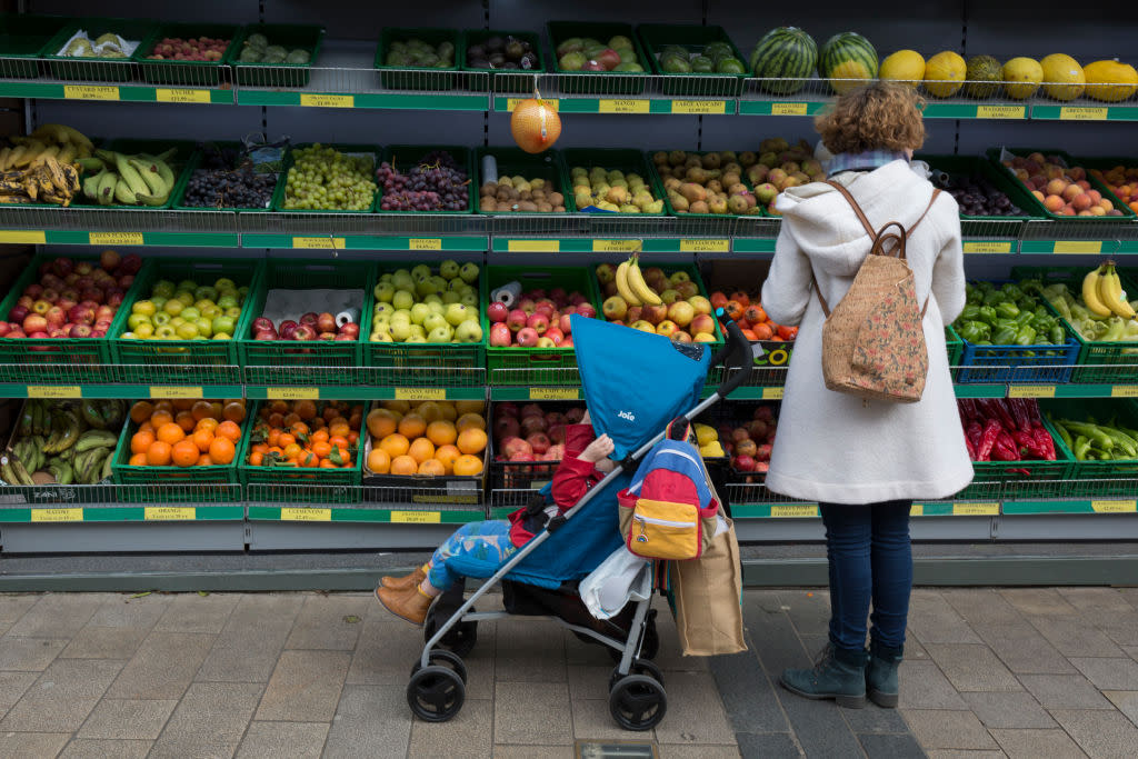 Mother Buys Fruit For Child