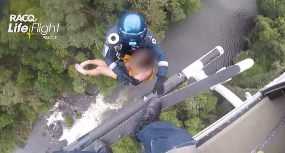 One of the boys is pulled to the waiting helicopter above Kondalilla Falls on Queensland’s Sunshine Coast