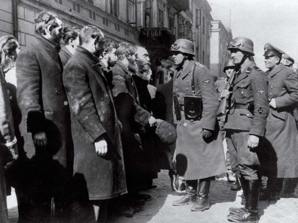 Nazi soldiers questioning Jews after the Warsaw Ghetto Uprising in 1943. Black Ribbon Day is commemorated to remember the victims of Nazism and Stalinism: OFF/AFP/Getty