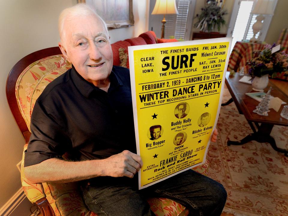 Tris Schnepper of Rochester holds up a reproduction poster in his home on Friday, February 9, 2024, of the last concert performed by Buddy Holly, Ritchie Valens and J.P. Richardson Jr., the Big Bopper, at the Surf Ballroom in Clear Lake, Iowa, in 1959. The three, along with pilot Roger Peterson, were killed in a plane crash.