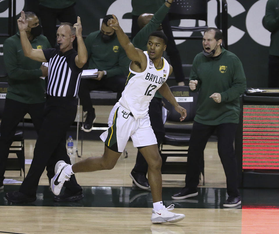 Baylor guard Jared Butler (12) reacts after score a three point shot against Oklahoma State in the second half of an NCAA college basketball game, Thursday, March 4, 2021, in Waco, Texas. (AP Photo/Jerry Larson)