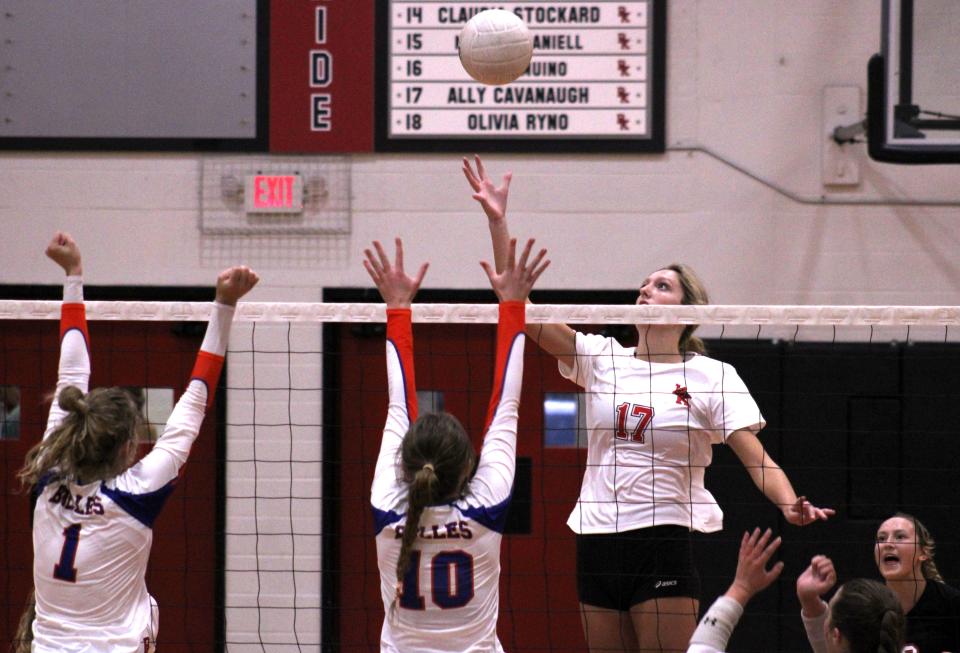 Bishop Kenny's Ally Cavanaugh (17) prepares to hit the ball against the Bolles defense of Grace Albaugh (1) and Sally Cleland (10) during a District 4-4A FHSAA high school volleyball championship on October 20, 2022. [Clayton Freeman/Florida Times-Union]