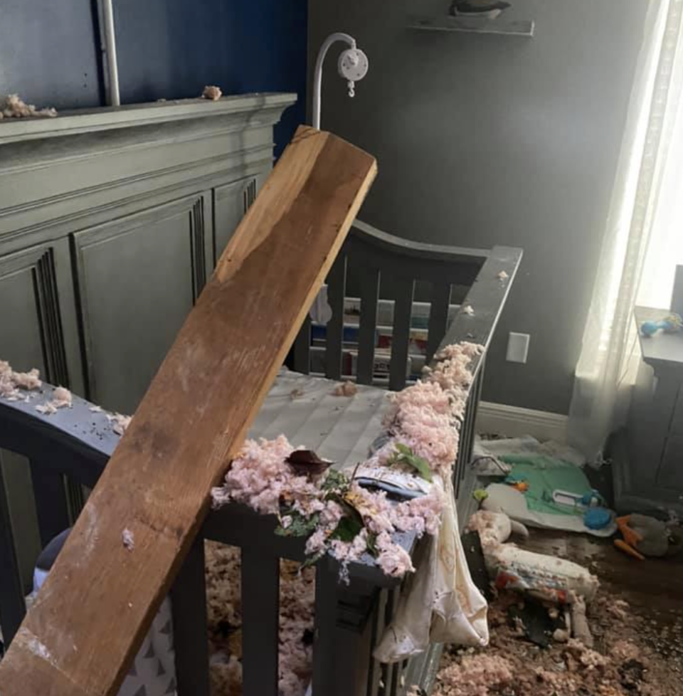 The bedroom of a baby boy damaged by a tree.