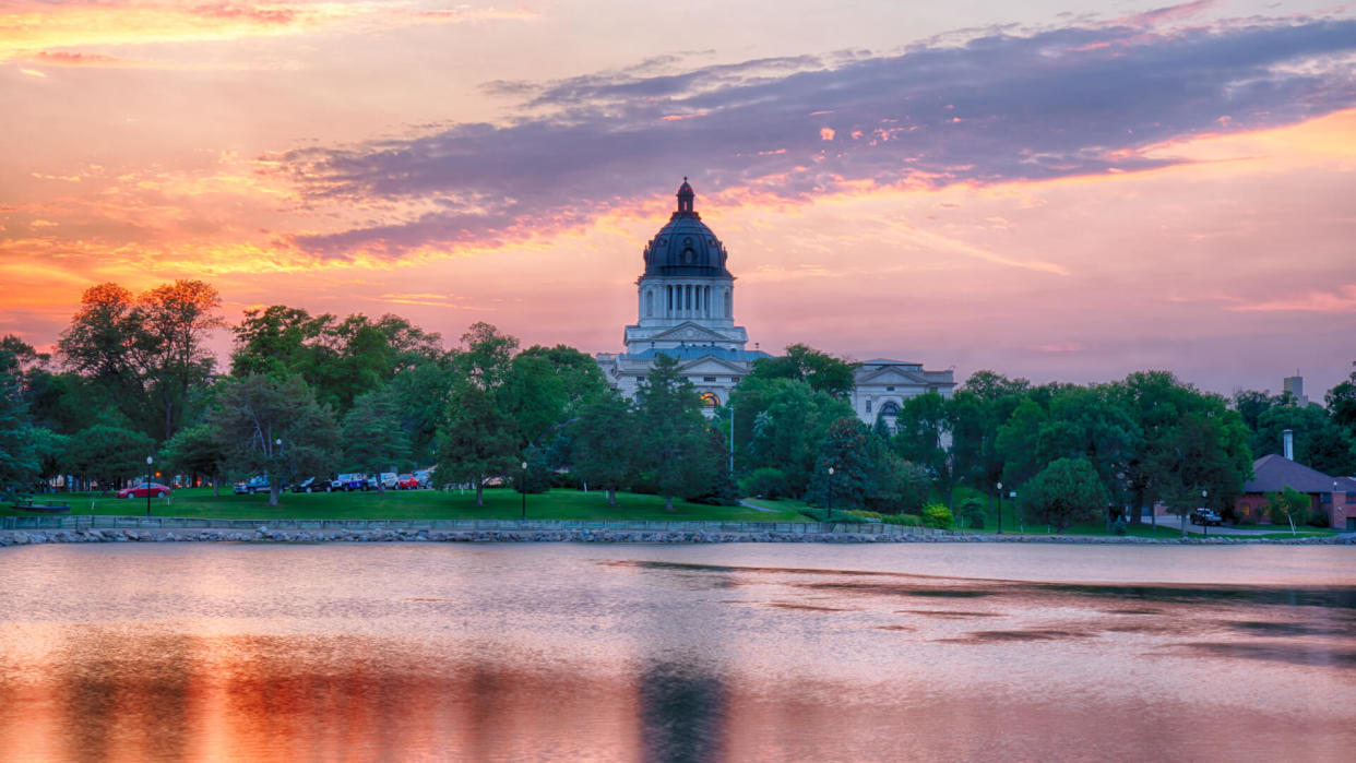 PIERRE, SD - JULY 9, 2018: South Dakota Capital Building along Capitol Lake in Pierre, SD at sunset.