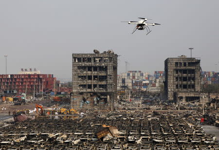 A drone operated by paramilitary police flies over the site of last week's explosions at Binhai new district in Tianjin, China, August 17, 2015. REUTERS/Kim Kyung-Hoon