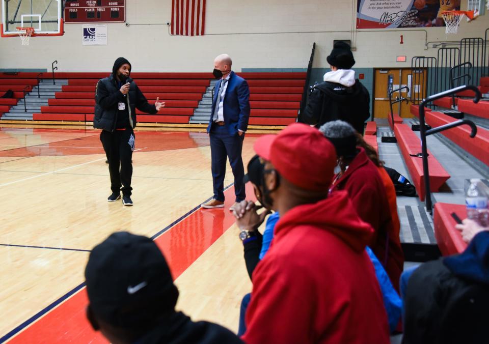 Terrance Cooper, left, of People Ready Activating Youth (P.R.A.Y.) thanks Lansing Superintendent Ben Shuldiner on Feb. 23 for working with school officials and citizen groups during a town hall  at Everett High School.